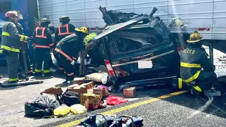 Florida Turnpike semi-truck crash scene with minivan lodged beneath trailer